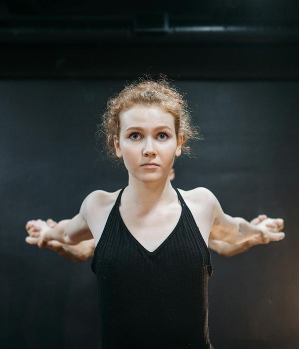 Woman in a fluid cardio pose, looking calm and focused.